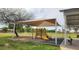 Playground with slide under covered picnic area in park at 444 W Fabens Ln, Gilbert, AZ 85233