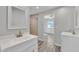 Bright bathroom featuring double vanity, a large mirror, and walk in shower at 4617 N 8Th Pl, Phoenix, AZ 85014