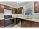 Updated kitchen showcasing stainless steel appliances, stone countertops, and generous cabinet space at 4617 N 8Th Pl, Phoenix, AZ 85014
