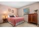 Cozy bedroom featuring neutral walls, carpet floors, and a window for natural light at 5741 W Purdue Cir, Glendale, AZ 85302