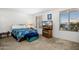 Bright bedroom with carpet, large windows, and a television for entertainment at 5741 W Purdue Cir, Glendale, AZ 85302