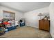 Spacious empty bedroom with carpet floors and a window bringing in natural light at 5741 W Purdue Cir, Glendale, AZ 85302