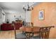 Cozy dining area adjacent to the living room, showcasing a chandelier and modern furnishings at 5741 W Purdue Cir, Glendale, AZ 85302