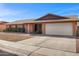 Charming brick home featuring a two-car garage, low maintenance yard, and inviting entryway at 5741 W Purdue Cir, Glendale, AZ 85302