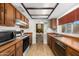Traditional kitchen featuring wood cabinets, laminate countertops, and essential appliances at 5741 W Purdue Cir, Glendale, AZ 85302
