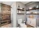 Bright bathroom with a walk-in shower, floating shelves, and rustic wood-look flooring at 601 E Winter Dr, Phoenix, AZ 85020