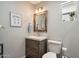 Bright bathroom showcases a modern vanity, framed mirror, toilet, and decorative touches at 601 E Winter Dr, Phoenix, AZ 85020