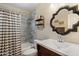 Well-lit bathroom with decorative mirror, modern vanity, and shower-tub combination with tiled walls at 601 E Winter Dr, Phoenix, AZ 85020