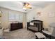 A cozy room with neutral carpet and dark wood furnishings, including a crib and rocking chair at 601 E Winter Dr, Phoenix, AZ 85020
