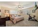 Cozy bedroom with neutral tones, plantation shutters, ceiling fan, and comfortable carpeting at 601 E Winter Dr, Phoenix, AZ 85020
