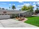 Beautiful single-story home with a green lawn, solar panels, and inviting front porch seating area at 601 E Winter Dr, Phoenix, AZ 85020