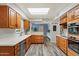 Spacious kitchen featuring wood cabinets, stainless appliances, a skylight, and durable, stylish flooring at 601 E Winter Dr, Phoenix, AZ 85020