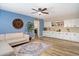 Cozy living room with a modern sofa, stylish rug, built-in cabinets, and a decorative clock at 601 E Winter Dr, Phoenix, AZ 85020