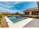 Backyard featuring a sparkling pool, lounge chairs, well manicured landscaping, and an outdoor kitchen at 6209 E Bramble Berry Ln, Cave Creek, AZ 85331