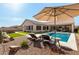 Relaxing backyard pool area with comfortable lounge chairs, a covered patio, and vibrant greenery at 6209 E Bramble Berry Ln, Cave Creek, AZ 85331