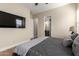 Comfortable bedroom featuring a TV, ceiling fan, and a view of the ensuite bathroom at 6209 E Bramble Berry Ln, Cave Creek, AZ 85331