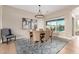 Dining room features a round table, stylish chandelier, and a view of the outdoor pool at 6209 E Bramble Berry Ln, Cave Creek, AZ 85331