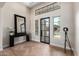 Bright, elegant foyer with soaring ceilings, herringbone floors, statement mirror and stylish lighting at 6209 E Bramble Berry Ln, Cave Creek, AZ 85331