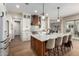 Bright kitchen showcasing a large island with seating, wood accents and modern appliances at 6209 E Bramble Berry Ln, Cave Creek, AZ 85331