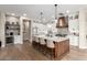 Stylish kitchen with island seating, custom cabinetry, wooden hood vent and stainless steel appliances at 6209 E Bramble Berry Ln, Cave Creek, AZ 85331