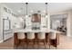Bright, open kitchen features a large island with seating and modern, stainless steel appliances at 6209 E Bramble Berry Ln, Cave Creek, AZ 85331