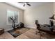 Home office space with modern decor, a treadmill, a desk, and bright window light at 6209 E Bramble Berry Ln, Cave Creek, AZ 85331