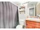 Cozy bathroom features updated vanity, mirror, and convenient shelving for storage and decorative items at 623 W Guadalupe Rd # 214, Mesa, AZ 85210