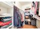 Walk-in closet showcasing organized shelving, hanging clothes, storage bins and personal belongings at 623 W Guadalupe Rd # 214, Mesa, AZ 85210