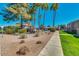 Expansive community grounds with desert landscaping, shade trees, and paved walkways for residents to enjoy at 623 W Guadalupe Rd # 214, Mesa, AZ 85210
