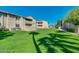Spacious community grounds with lush lawns, mature trees, and well-maintained buildings create a welcoming atmosphere at 623 W Guadalupe Rd # 214, Mesa, AZ 85210