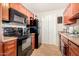 Well-equipped kitchen featuring modern appliances, wood cabinets, and ample counter space at 623 W Guadalupe Rd # 214, Mesa, AZ 85210
