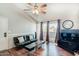 Inviting living room with wood floors, modern fan, and a sliding door to the outside at 623 W Guadalupe Rd # 214, Mesa, AZ 85210