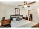 Comfortable main bedroom with a ceiling fan, wood-look flooring, and closet at 623 W Guadalupe Rd # 214, Mesa, AZ 85210