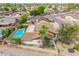 Aerial view of a backyard with a fenced pool, palm trees, and a covered patio, creating a private oasis at 6608 S Willow Dr, Tempe, AZ 85283
