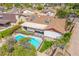 Aerial view of a backyard with a sparkling blue pool, covered patio, and well-maintained landscaping at 6608 S Willow Dr, Tempe, AZ 85283