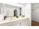 Bright bathroom featuring double sinks, a large mirror, and a view into a well-lit closet at 6608 S Willow Dr, Tempe, AZ 85283