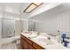 Bathroom with double sinks, wood cabinets, and a shower/tub combination at 6608 S Willow Dr, Tempe, AZ 85283