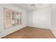 Sunlit bedroom with wood floors, a ceiling fan, and shuttered windows at 6608 S Willow Dr, Tempe, AZ 85283