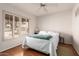 Bright bedroom features shutters and a ceiling fan, and hardwood floors at 6608 S Willow Dr, Tempe, AZ 85283