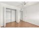 Empty bedroom with hardwood floors, ceiling fan, and walk-in closet at 6608 S Willow Dr, Tempe, AZ 85283
