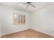 Light filled bedroom with hardwood floors, shutters, and a ceiling fan at 6608 S Willow Dr, Tempe, AZ 85283