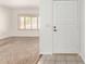 Inviting entryway with neutral carpeting, white walls, and bright natural light through shuttered window at 6608 S Willow Dr, Tempe, AZ 85283