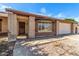 Attractive home featuring a brick facade, covered entryway, and a well-maintained front yard with a two-car garage at 6608 S Willow Dr, Tempe, AZ 85283