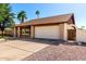 A charming single-story brick home featuring a two-car garage and gravel landscaping at 6608 S Willow Dr, Tempe, AZ 85283