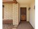 A close-up of the front door with unique metalwork, brick accents, and a welcoming porch area at 6608 S Willow Dr, Tempe, AZ 85283