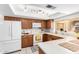 Well-lit kitchen featuring bright countertops, white appliances, and wood cabinetry at 6608 S Willow Dr, Tempe, AZ 85283