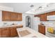 Functional kitchen featuring light countertops, wood cabinets, and essential appliances at 6608 S Willow Dr, Tempe, AZ 85283