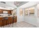 Cozy kitchen with a breakfast bar, bright lighting, and a view of the patio at 6608 S Willow Dr, Tempe, AZ 85283