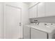 Efficient laundry room featuring a side-by-side washer and dryer and built in cabinets for storage at 6608 S Willow Dr, Tempe, AZ 85283