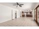 Open living area showcasing tile floors, a laundry closet, and a view of the kitchen at 6608 S Willow Dr, Tempe, AZ 85283